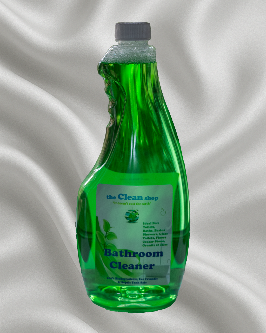 Green bottle of bathroom cleaner with a label on a gray background