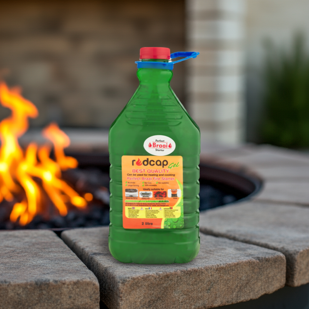 redcap Green bottle on a stone surface in front of a fire pit.