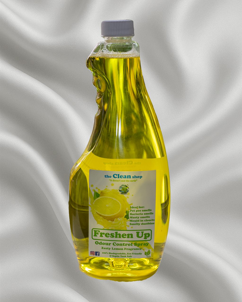 Bottle of 'Freshen Up' odour control spray with a lemon graphic on a gray background