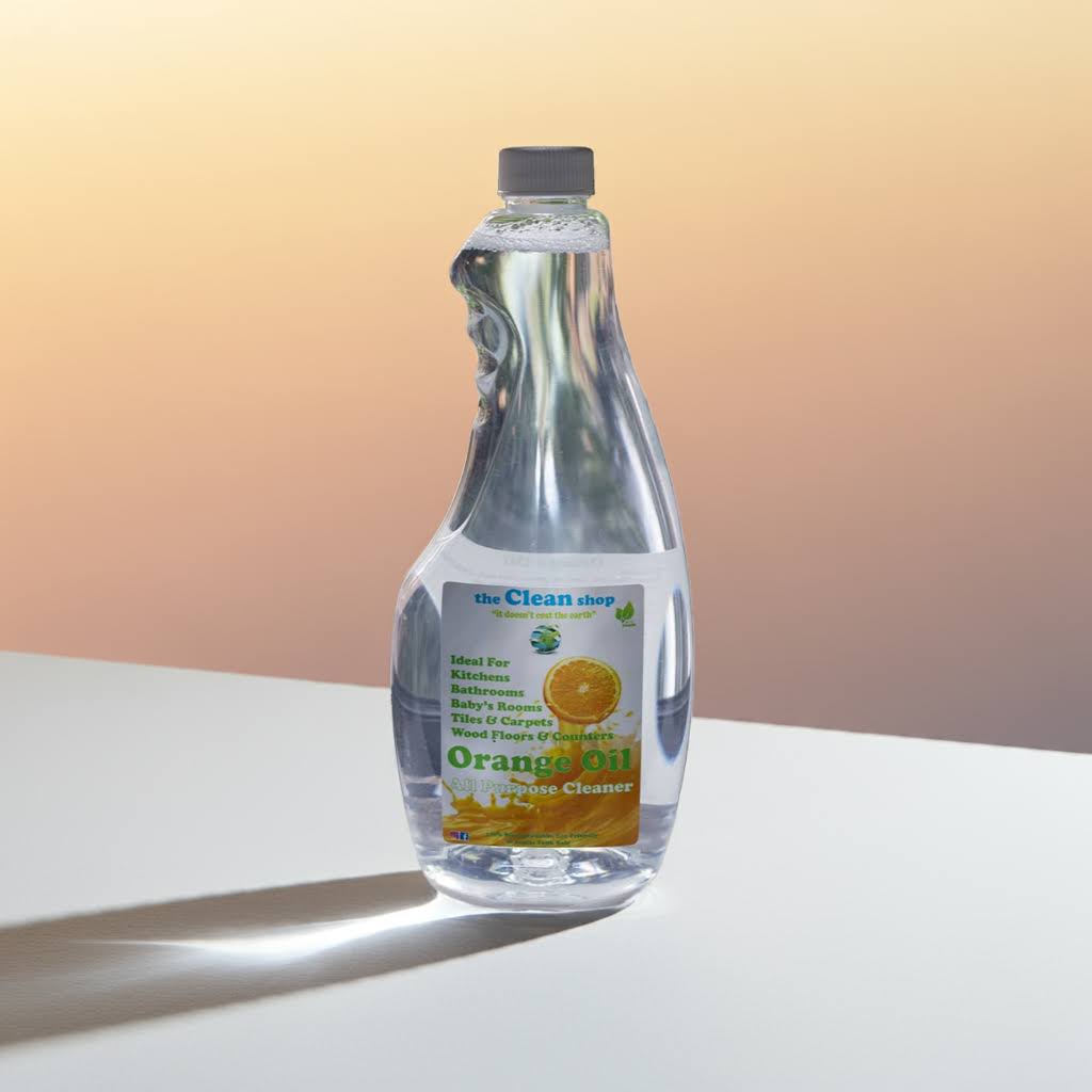 Bottle of Orange Oil Cleaner on a white surface with a gradient background