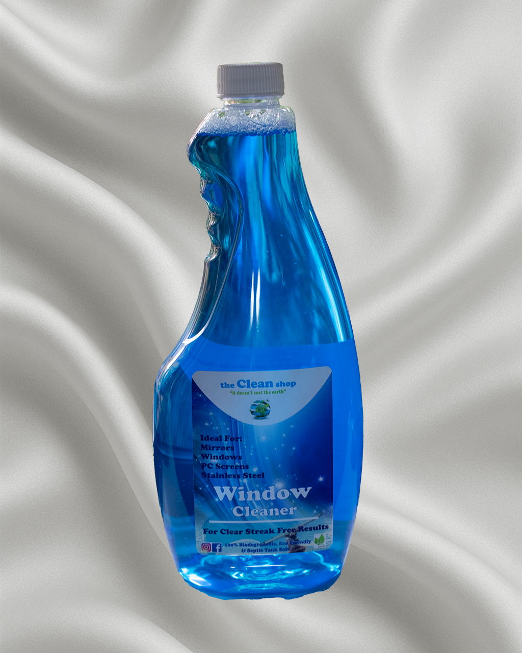 Blue bottle of window cleaner on a gray background